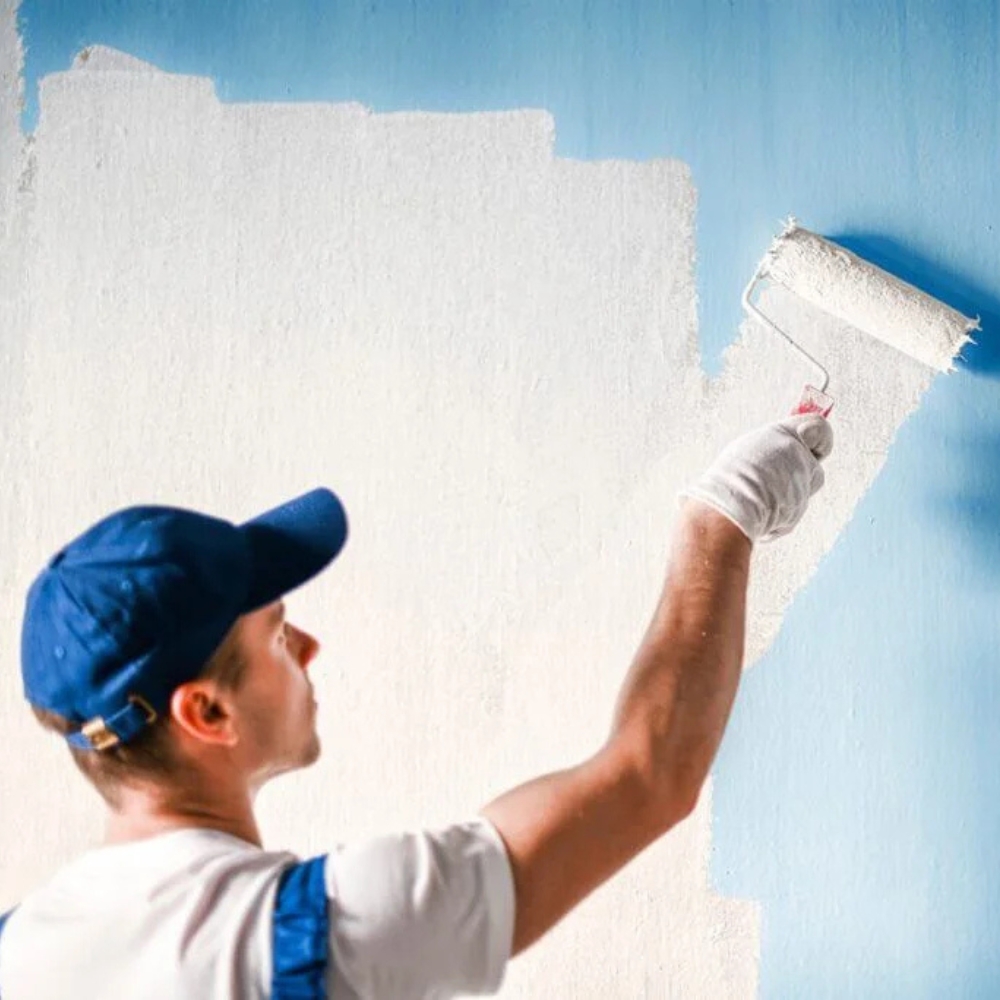 man painting a walll